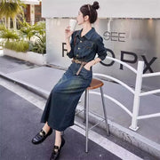 Woman in a denim outfit sitting on a stool outdoors, holding a drink.