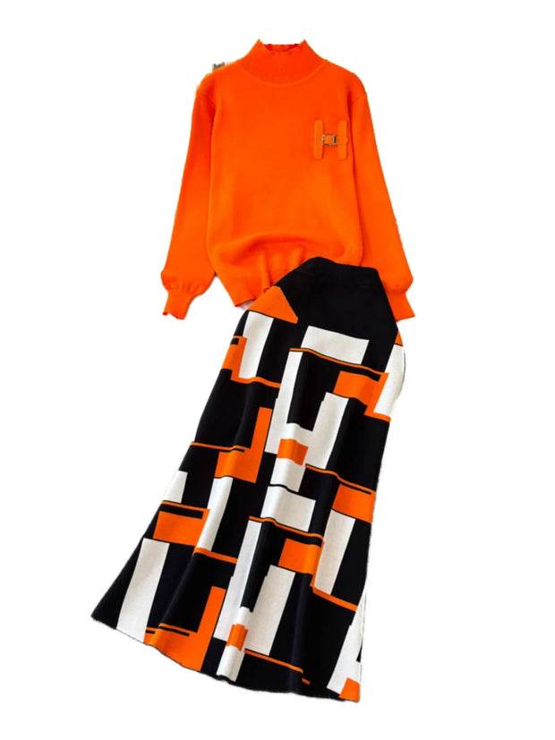 Orange sweater and black and white patterned pants on a white background
