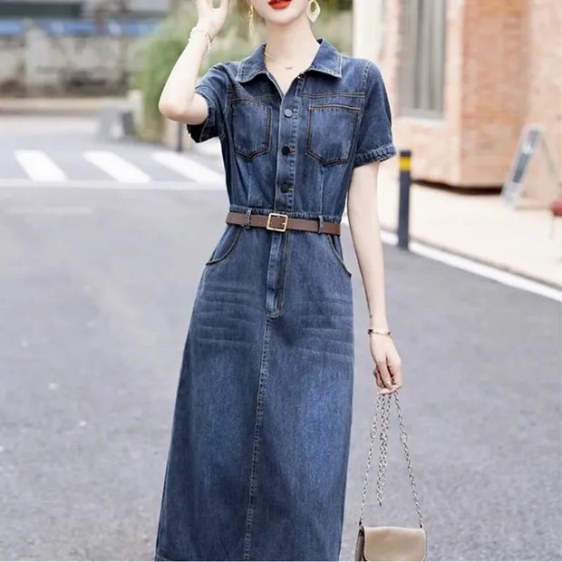 Woman wearing a denim dress on a street background