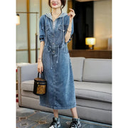 Woman wearing a denim dress in an indoor setting