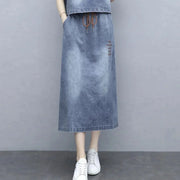 Denim skirt worn by a mannequin on a gray background