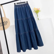 Blue denim skirt on a hanger against a white background