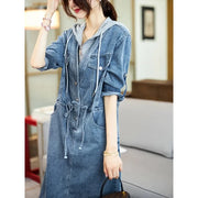 Woman wearing a denim dress in an indoor setting