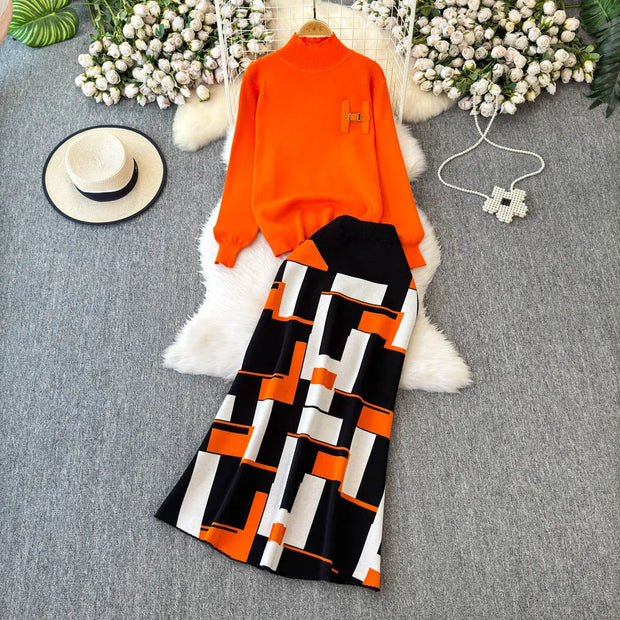 Orange top and black and white patterned pants on a gray surface with decorative elements.
