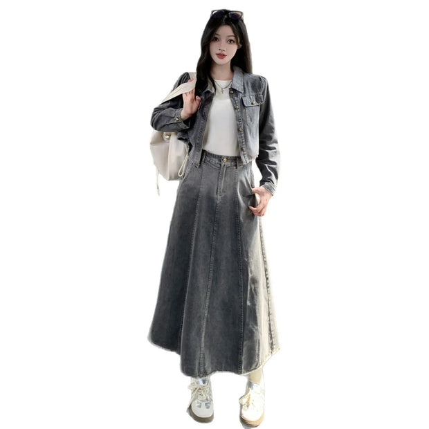 Person wearing a long denim skirt and jacket on a white background