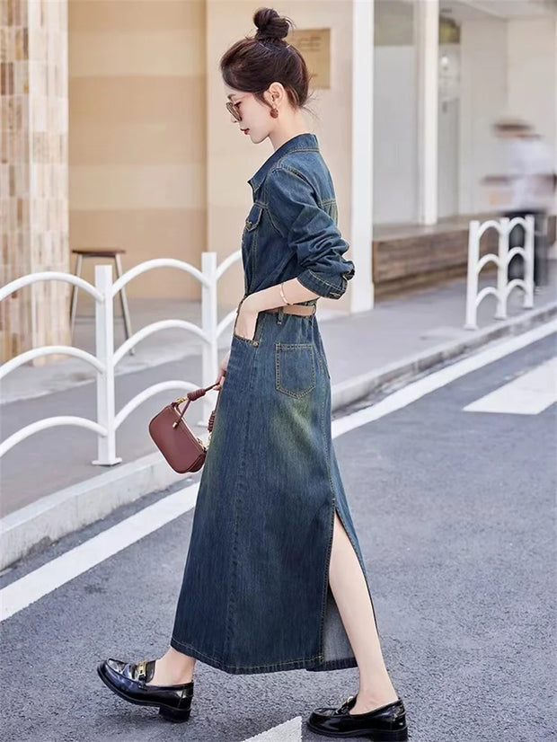 Woman wearing a long denim dress on a street.