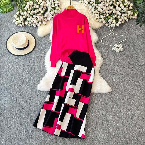 Pink top with geometric patterned pants on a gray surface with decorative elements.