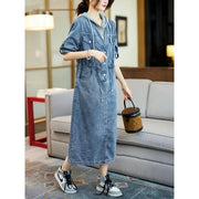 Woman wearing a denim dress in a living room setting
