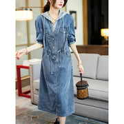 Woman wearing a denim dress in a living room setting